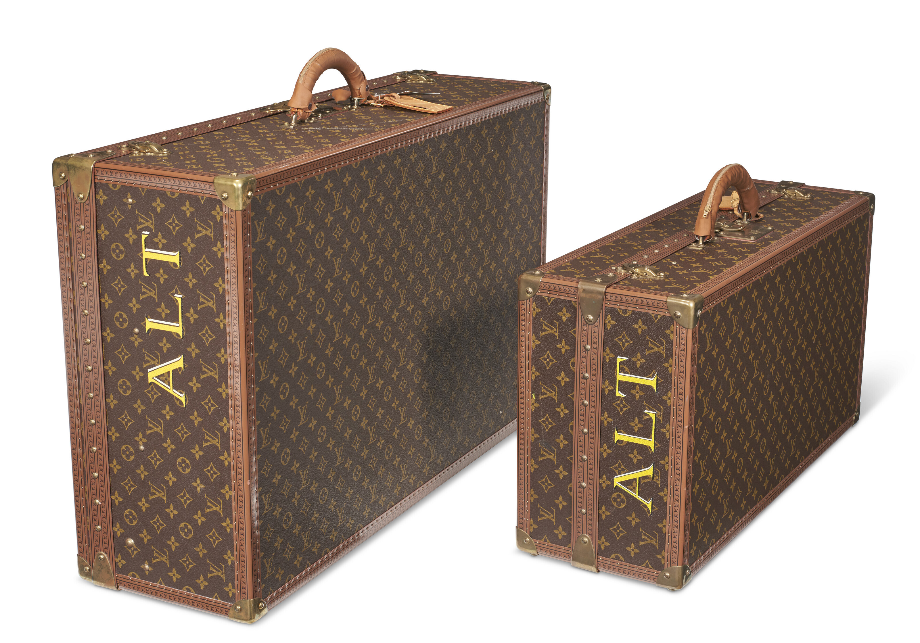A PAIR OF PERSONALIZED BROWN MONOGRAM CANVAS HARDSIDED SUITCASES