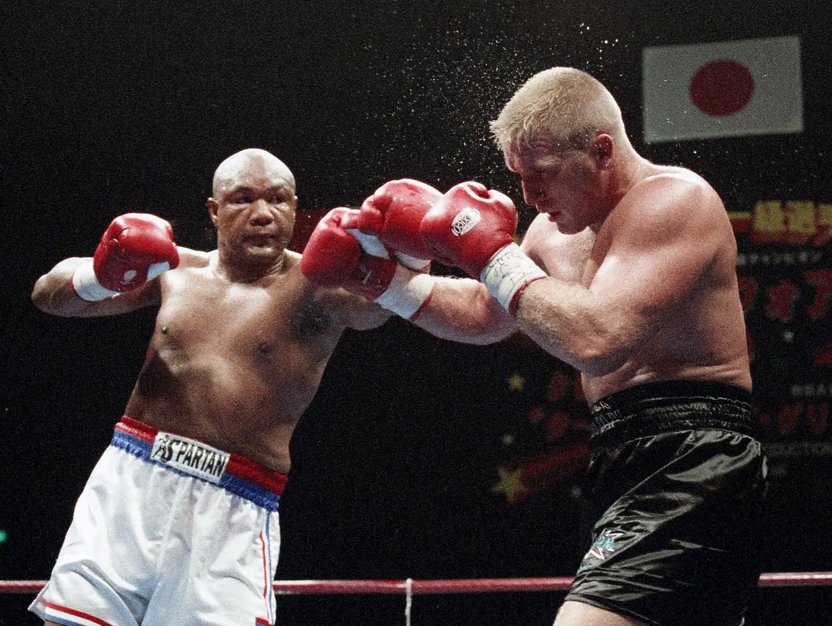 会見で力こぶを見せるジョージ・フォアマン（1996年10月27日撮影