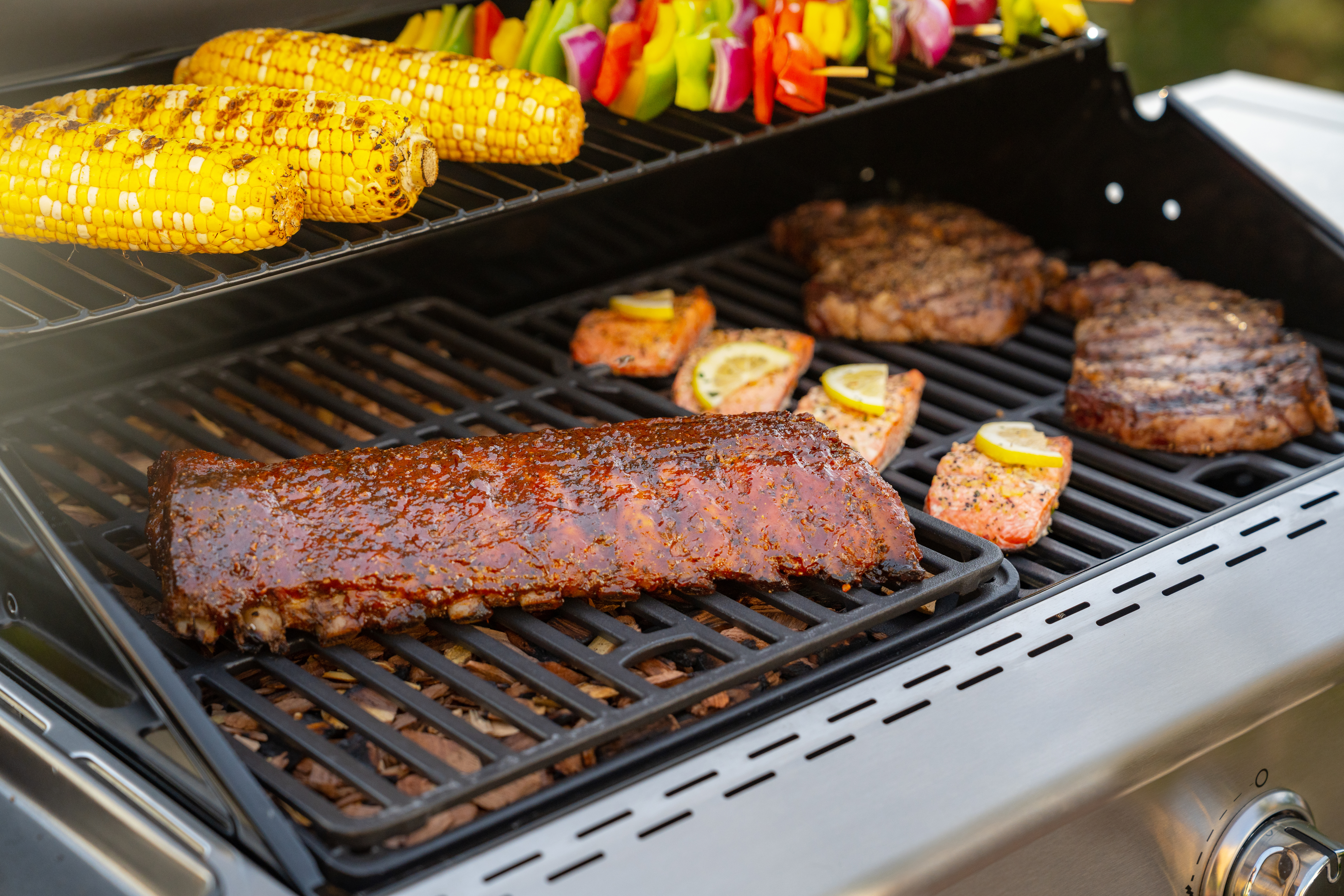 Deluxe 4-Burner Gas Grill - Black with Ceramic Searing Side | Nexgrill