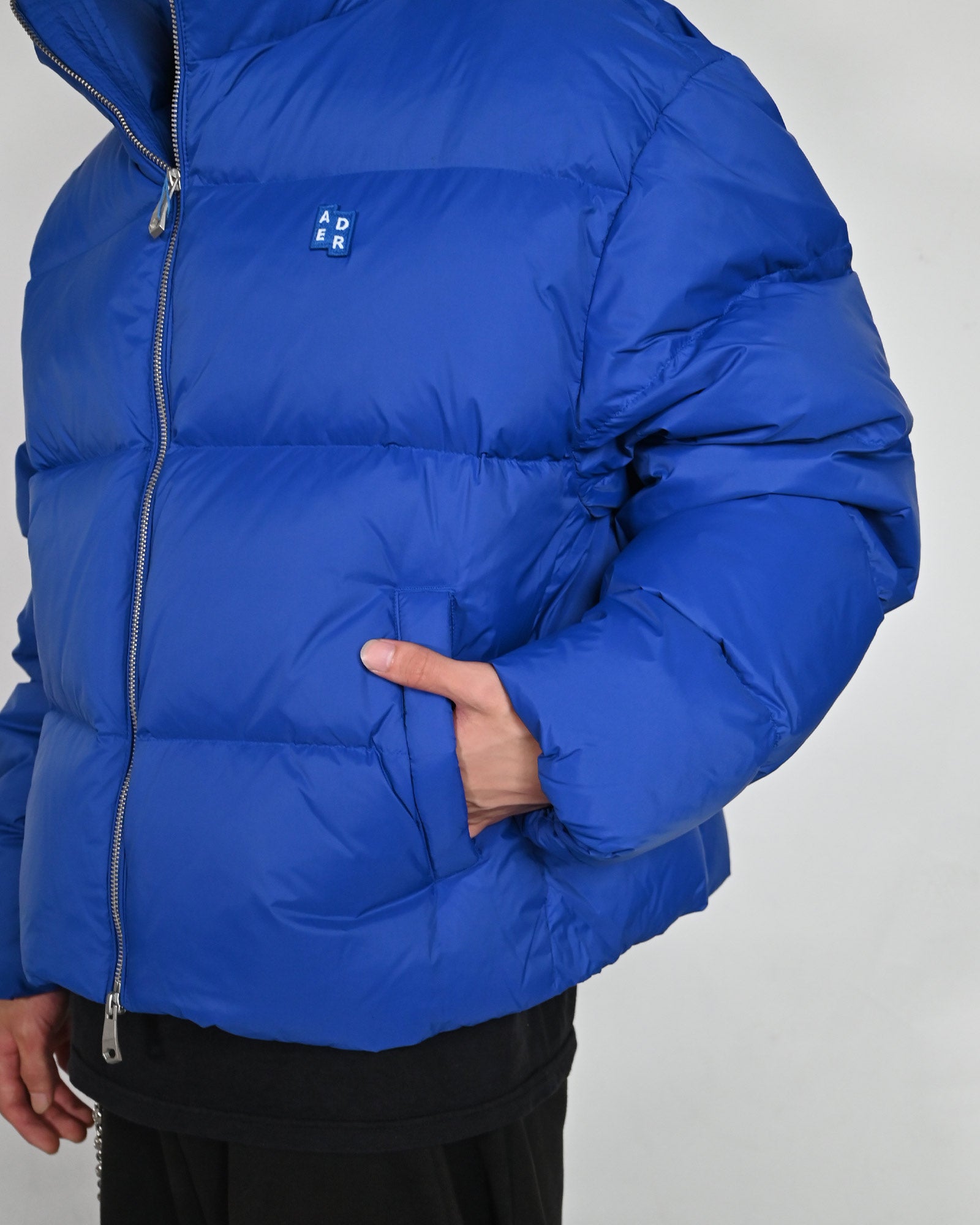 Ader Error(アーダーエラー)「 TRS TAG PUFFER JACKET 01 / BLUE