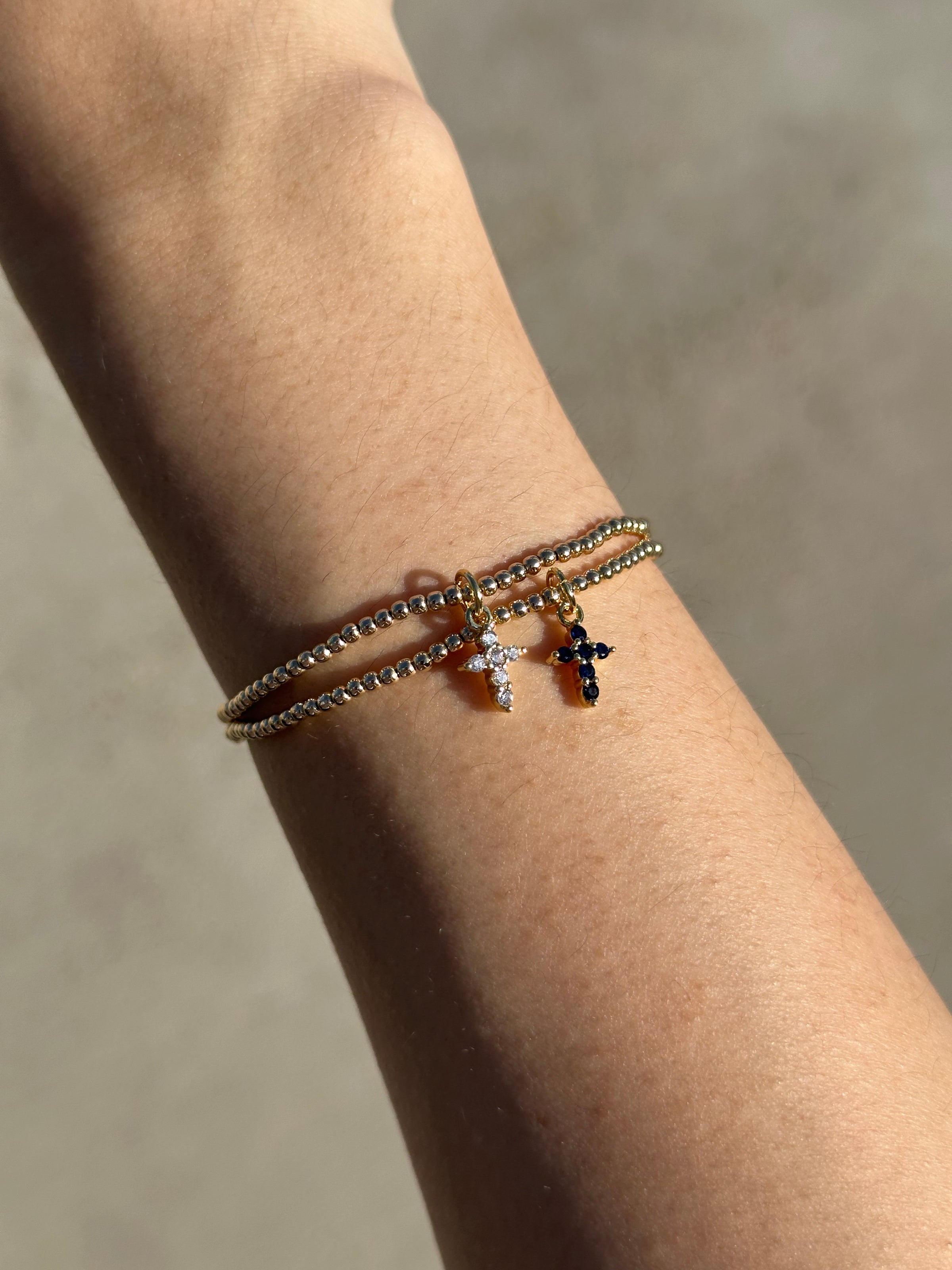 THE CROSS CHARM BRACELET – ERICA WOOLSTON | OFFICIAL SITE