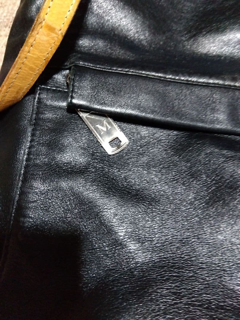 レザー製リュック 黒と黄 Mのロゴ