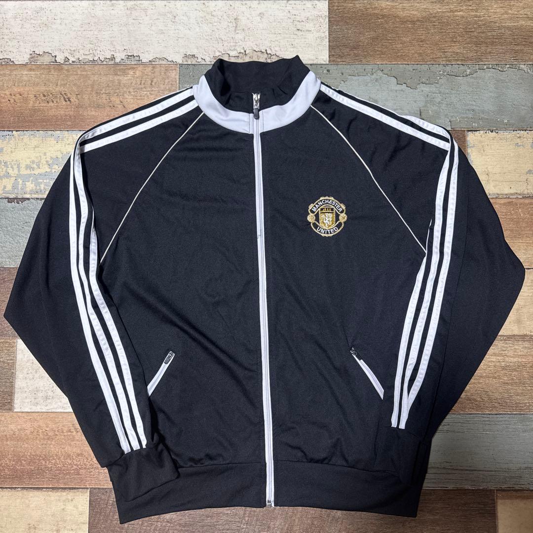 マンチェスター・ユナイテッド Lトラックジャケット3本ライン黒金