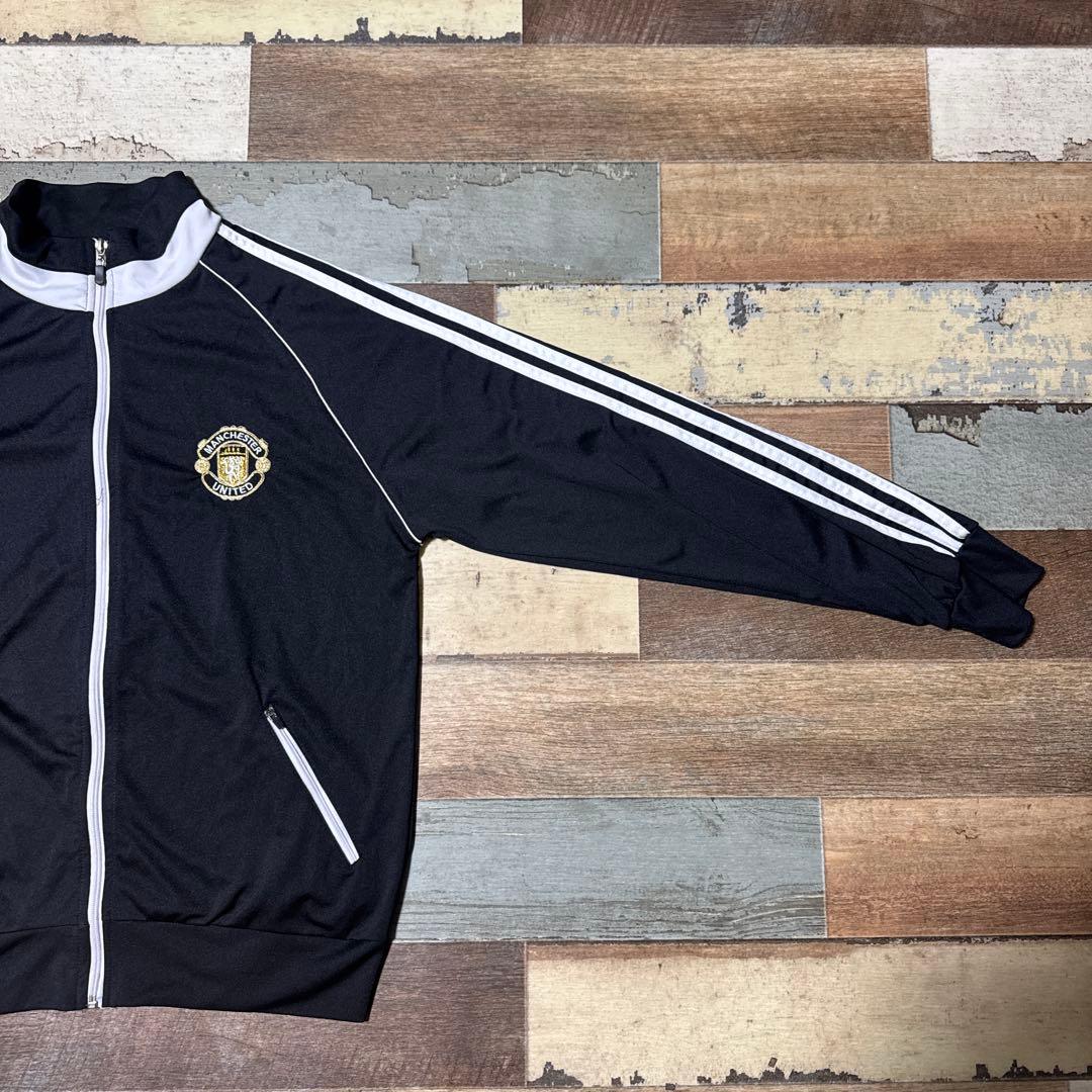 マンチェスター・ユナイテッド Lトラックジャケット3本ライン黒金